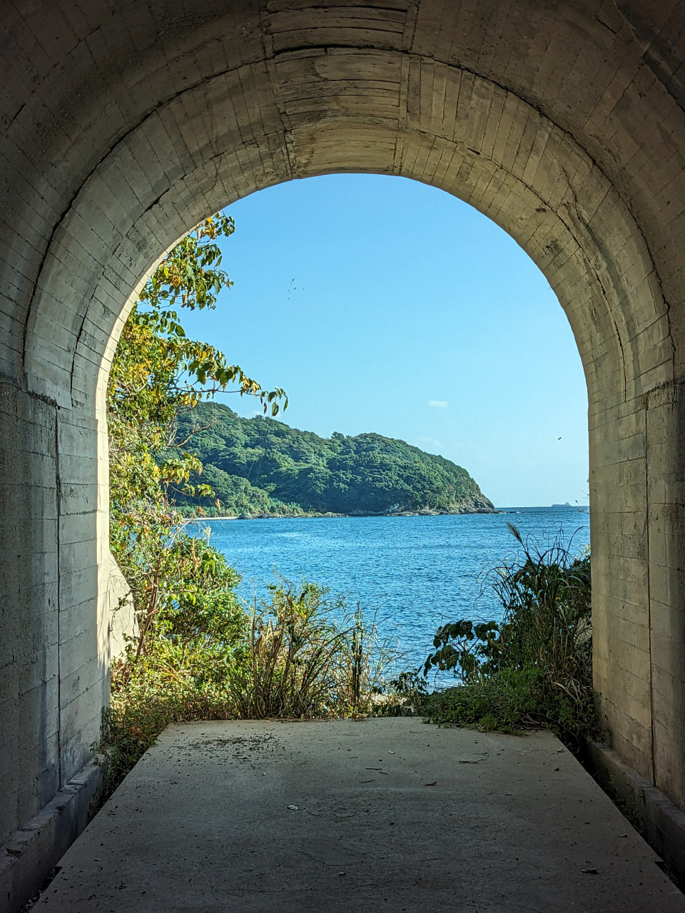 an ocean bay photo from inside a tunnel