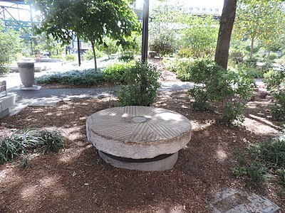 One of the Dutch Kills Millstones displayed in a NYC park.