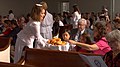 A Moravian diener serves bread to fellow members of her congregation during the celebration of a lovefest (2015).