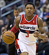 Bradley Beal is playing for the Washington Wizards dribbling a ball down the court