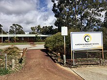 School entrance with a sign to the right