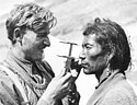 Nazi racial anthropologist measuring a man's skull on an Ahnenerbe expedition to Tibet