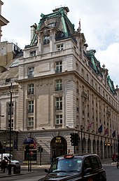 Side view of the Ritz hotel, Piccadilly, including a neon sign above an entrance