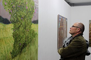 A man admiring a painting