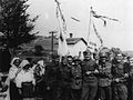 Cheerful German and Slovak soldiers posing with Ukrainian civilians in Komańcza, Poland, in 1939