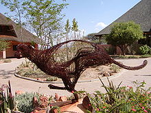 A cheetah sculpture in front of two buildings at the Cheetah Conservation Fund's Field and Research Centre in Otjiwarongo, Namibia