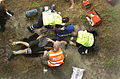 Paramedics attending to a man after a fall from a bridge