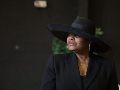 A widow in dressed in black at a funeral