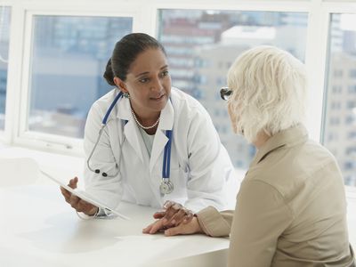 Indian doctor talking with patient