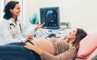 Pregnant young mom getting sonogram