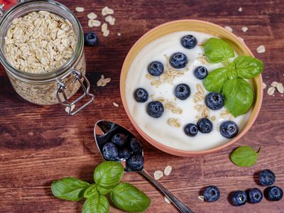 a bowl of yogurt complemented with blueberries and oatmeal