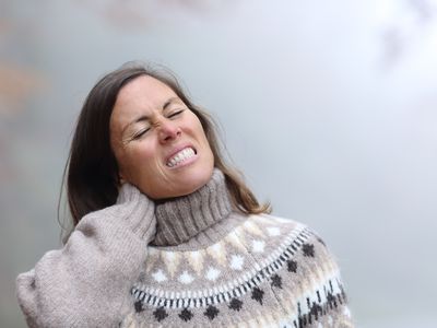 woman suffering neck ache in winter