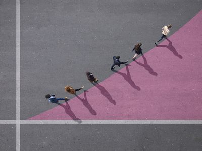 group of people walking from above on pavement with purple 