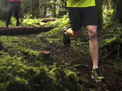 Individual running through a forest.