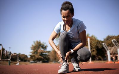 Woman with ankle pain during run