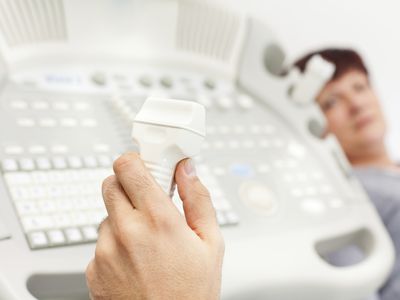 doctor's hand holding ultrasound device