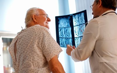 A doctor and his patient looking at an x-ray