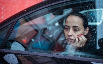 Portrait of sad woman in the car - stock photo