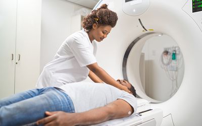 doctor preparing male patient for MRI scan in medical examination room