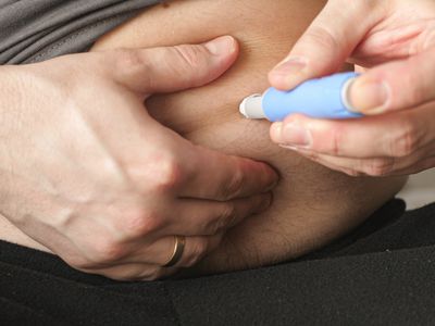 Person with obesity administering Ozempic injection into stomach area