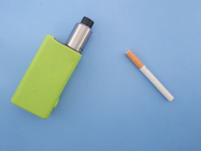 High Angle View Of Cigarettes On Blue Background