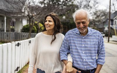 Two people walking in a neighborhood