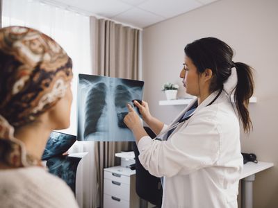 A doctor explaining a chest X-ray to patient