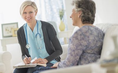 Nurse Visiting Patient At Home