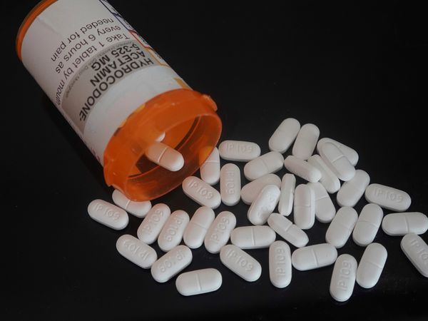 Hydrocodone pills spilling out of prescription bottle