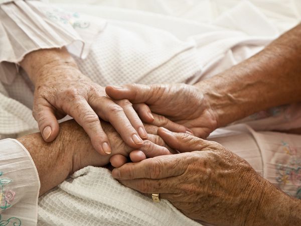 Two Old People Holding Hands