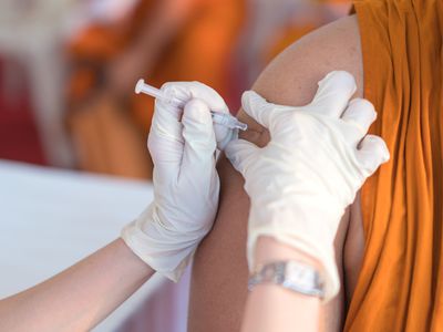 Nurse holding a syringe for the injection giving patient vaccine in hospital. Health care Concept