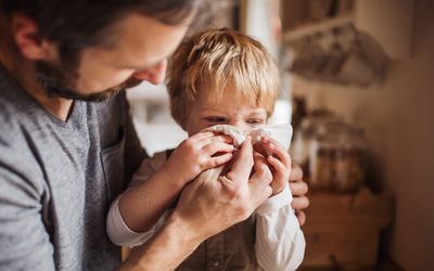 A father looking after a boy at home