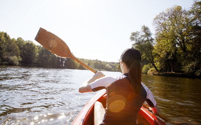 Woman rowing in a canoe