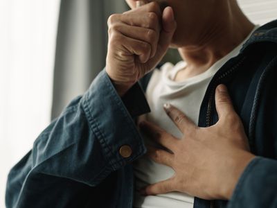 A man coughing