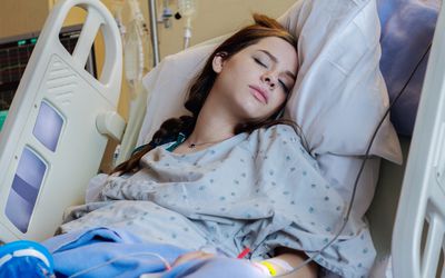 Teenage girl in hospital bed