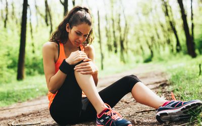 Woman holding knee in pain