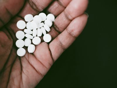 person holding aspirin 