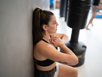 Woman squatting at the gym