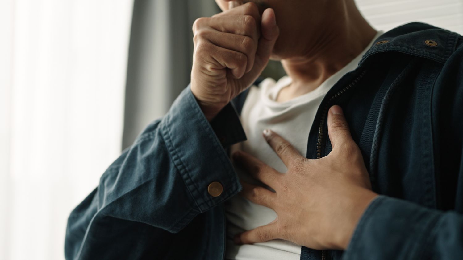 A man coughing