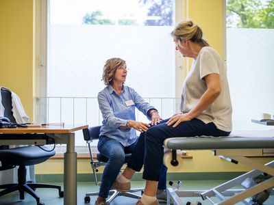 A woman receives knee pain treatment.