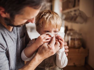 A father looking after a boy at home