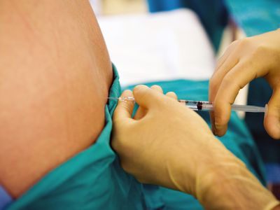 A doctor giving a patient an injection