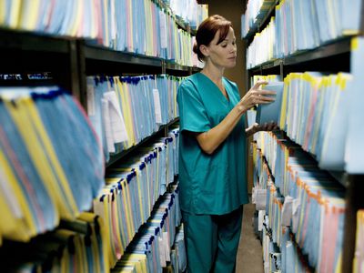 nurse in a medical file storage room