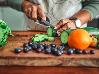 man chopping a cucumber