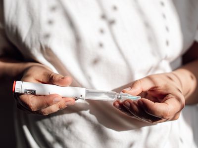 Woman holding a semaglutide injection pen, Ozempic