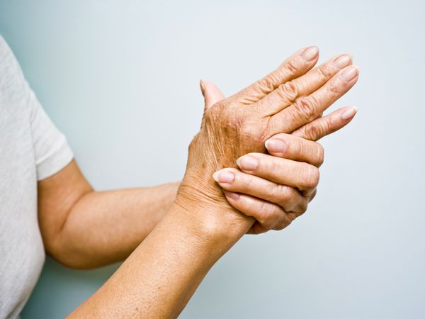 Woman rubbing her arthritic hand