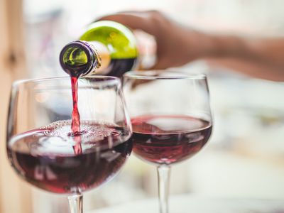 Pouring red wine in glasses