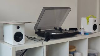 The Sony PS-LX310BT and Edifier M90 on a shelf.