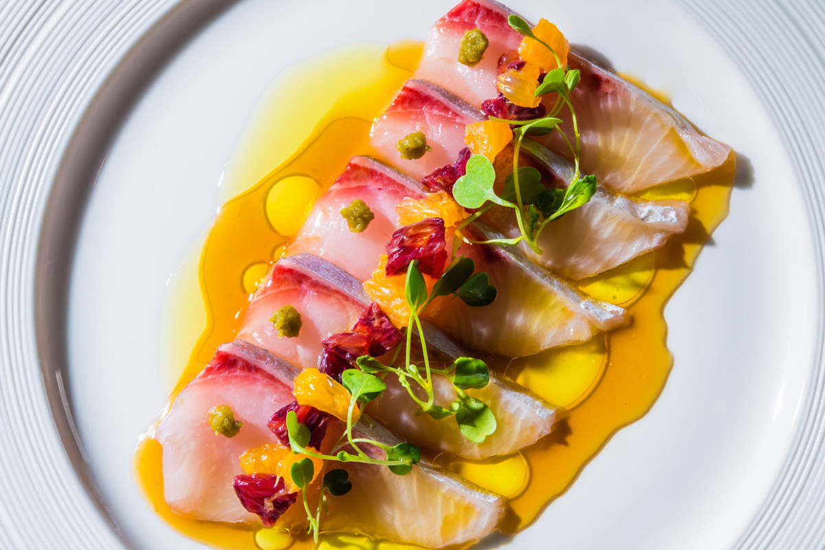 A plate of nigiri in a delicate yellow sauce.