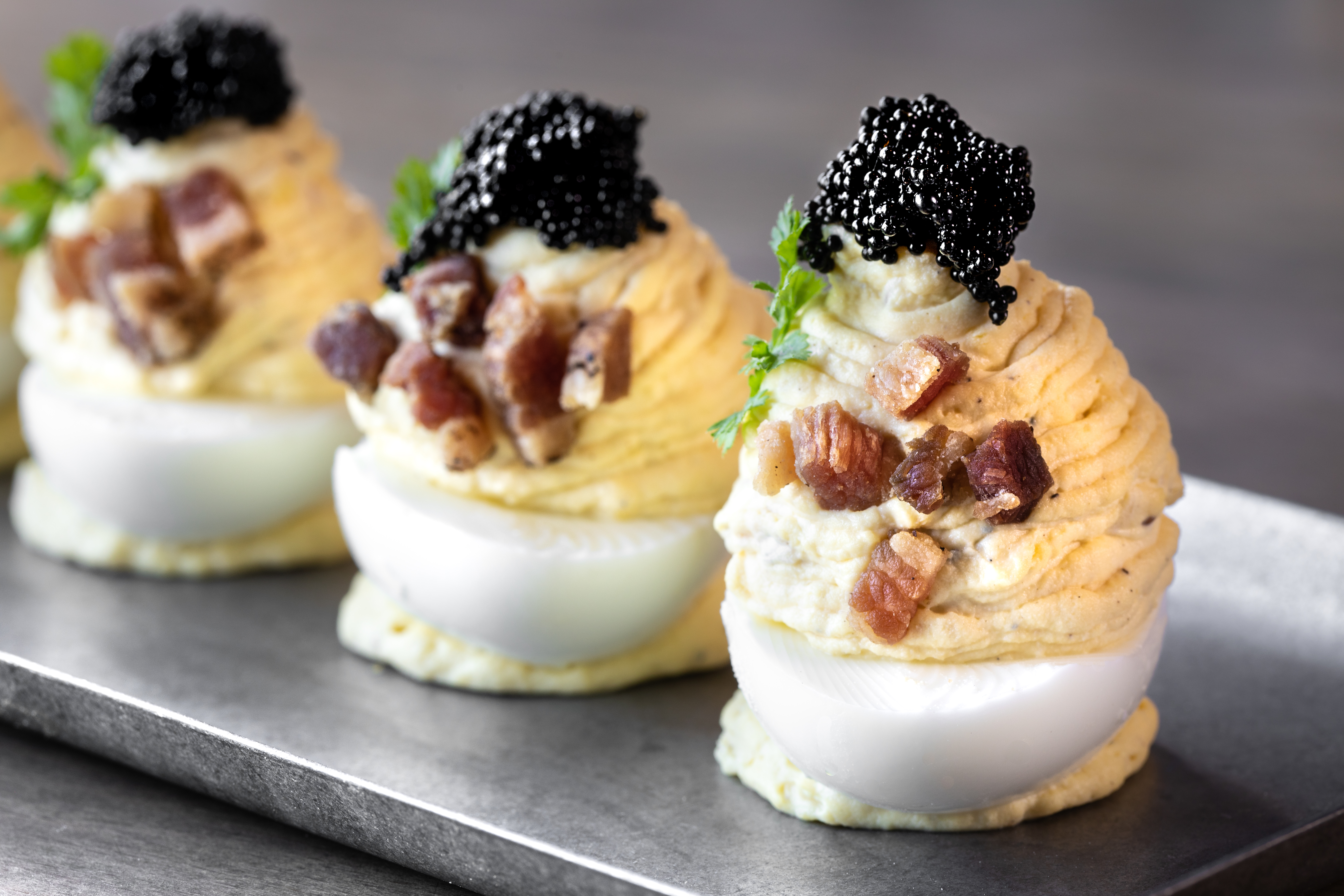 Deviled eggs with bacon and topped with caviar from Carson Kitchen